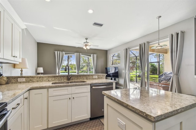 kitchen featuring pendant lighting, white cabinets, sink, and stainless steel appliances