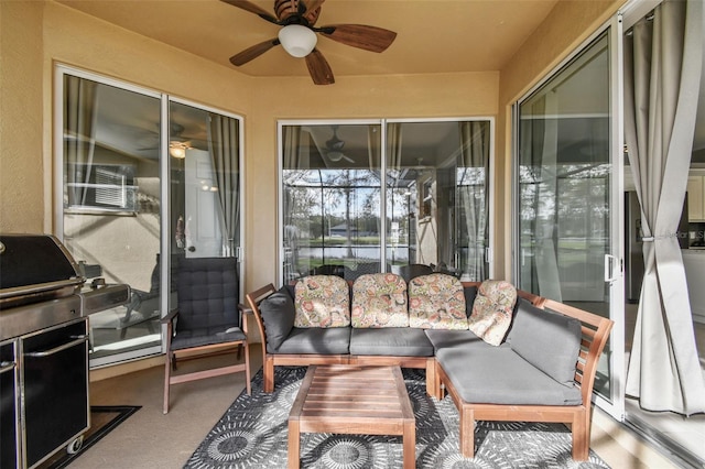 sunroom featuring ceiling fan