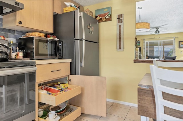 kitchen with light brown cabinets, stainless steel appliances, a textured ceiling, and ventilation hood