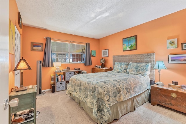 bedroom with light carpet and a textured ceiling