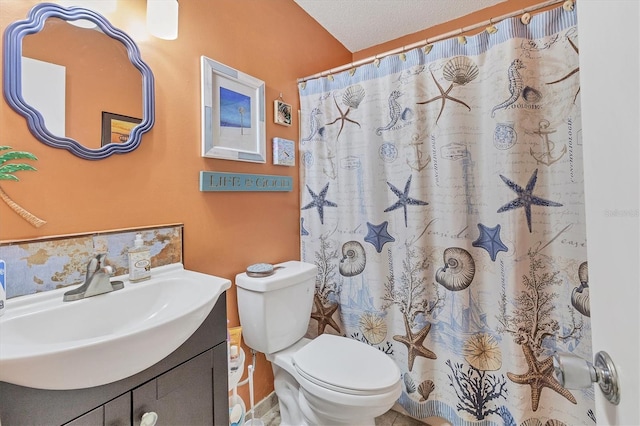 bathroom with vanity, a textured ceiling, toilet, and walk in shower