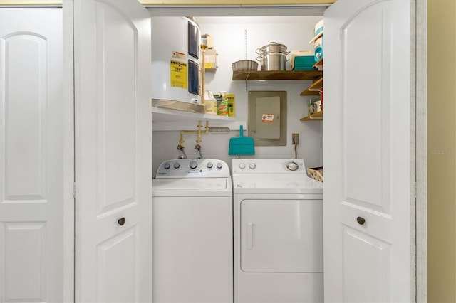 washroom featuring laundry area, electric panel, and washer and clothes dryer