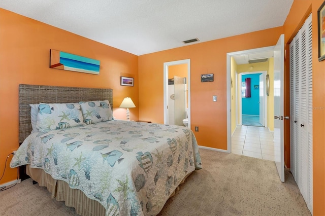 bedroom with light tile patterned floors, light carpet, visible vents, baseboards, and a closet