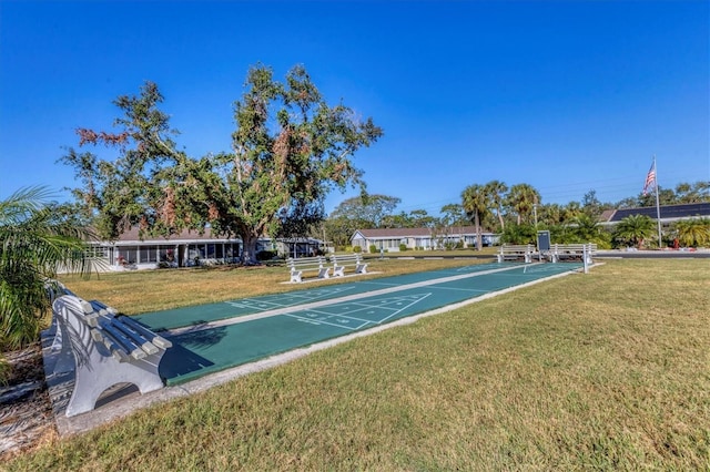 surrounding community featuring a yard and shuffleboard