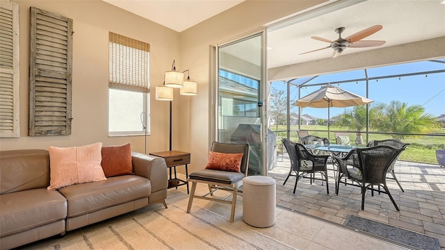 sunroom featuring ceiling fan