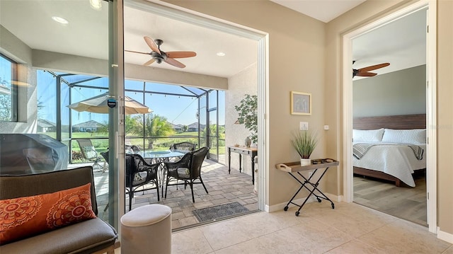 sunroom / solarium featuring ceiling fan