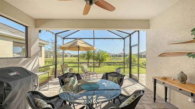 sunroom with ceiling fan and plenty of natural light