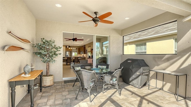 interior space featuring ceiling fan and a grill