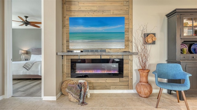 7525 Alumni Trl, Sarasota, FL 34243 - living room featuring ceiling fan, a glass covered fireplace, and tile patterned floors