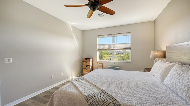 bedroom with ceiling fan and hardwood / wood-style flooring