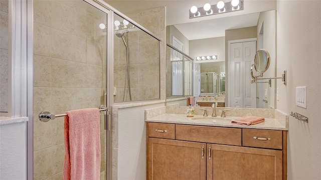 bathroom featuring an enclosed shower and vanity