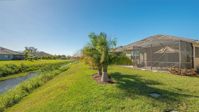 7525 Alumni Trl, Sarasota, FL 34243 - view of grassy yard with glass enclosure and a patio area