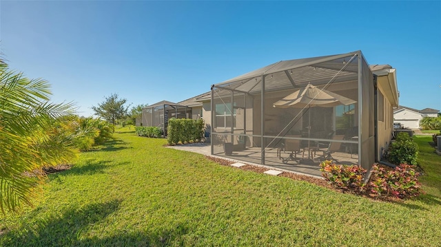 7525 Alumni Trl, Sarasota, FL 34243 - view of green lawn with a patio area and glass enclosure