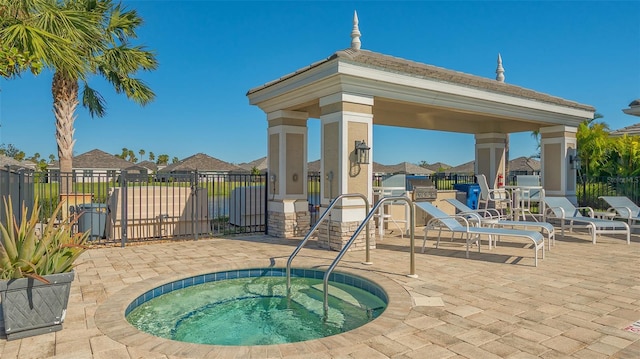 exterior space with a patio area, a gazebo, and a hot tub