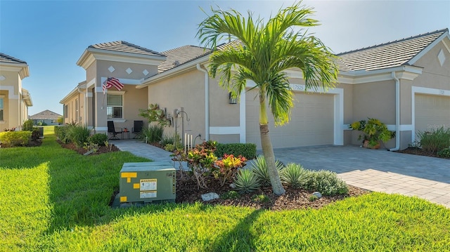 view of front of property with a front yard and a garage