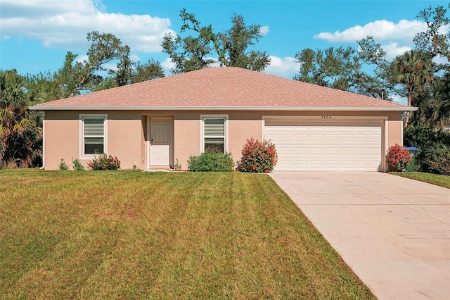 single story home with a garage and a front lawn