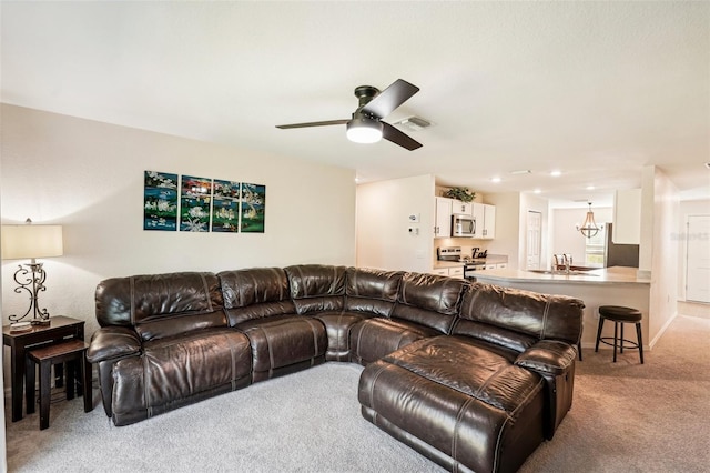 carpeted living room featuring ceiling fan