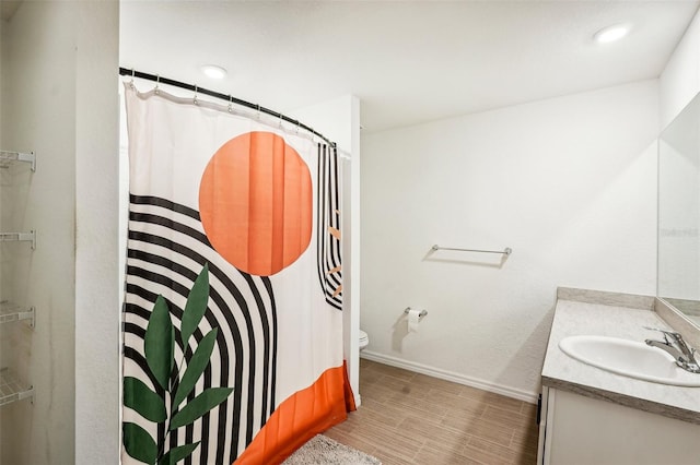 bathroom with vanity, toilet, and walk in shower