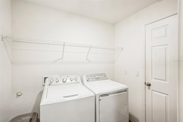 washroom with washing machine and clothes dryer