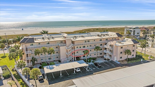 drone / aerial view featuring a view of the beach and a water view