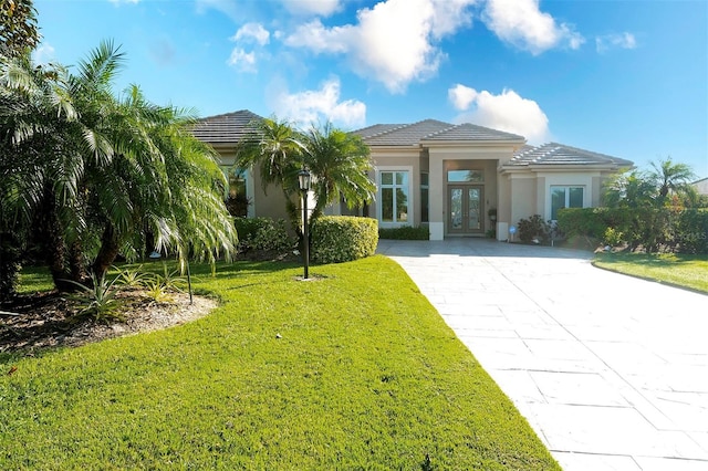 view of front of home featuring french doors and a front lawn