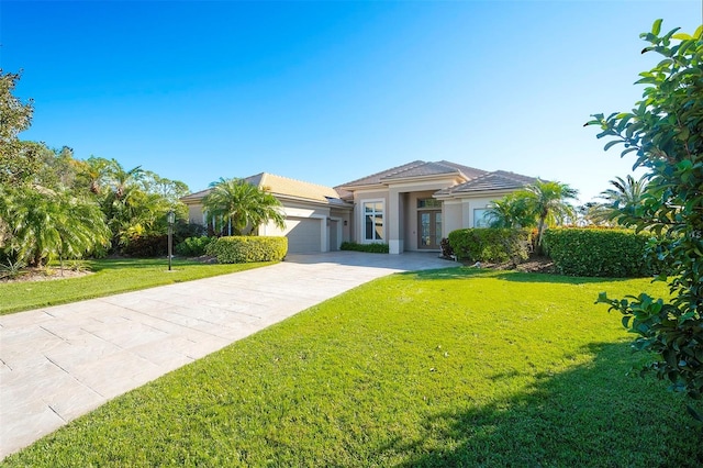 view of front of property featuring a garage, a front yard, and french doors