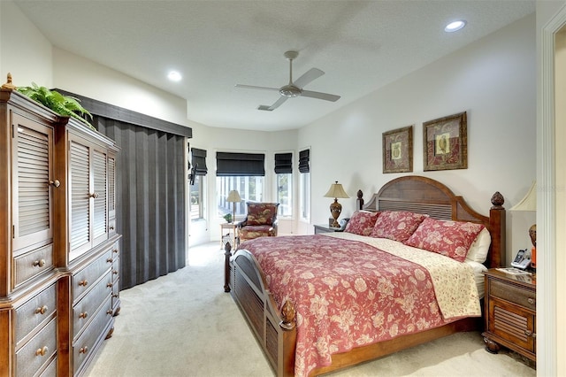 carpeted bedroom with a textured ceiling and ceiling fan