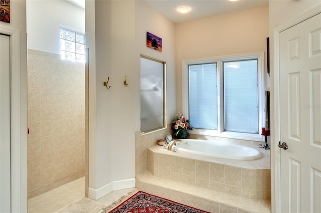 bathroom featuring shower with separate bathtub and tile patterned floors