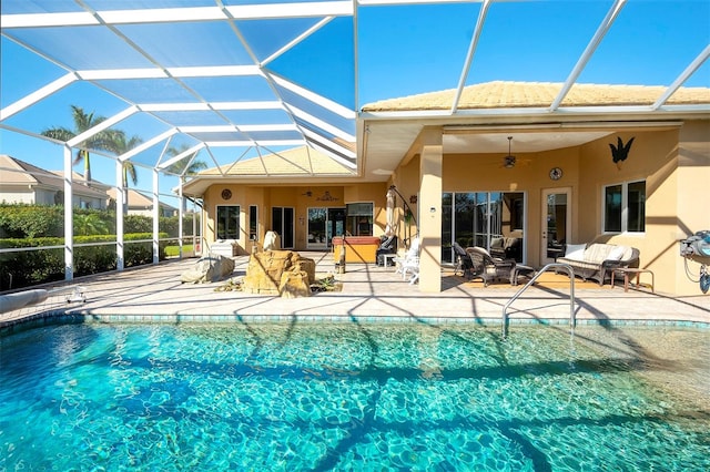 view of pool featuring ceiling fan, a patio, and glass enclosure