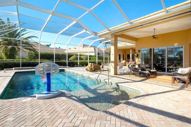 view of pool featuring a lanai, a patio area, and ceiling fan