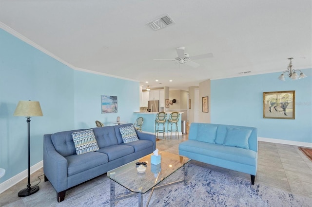 tiled living room with ceiling fan with notable chandelier and ornamental molding