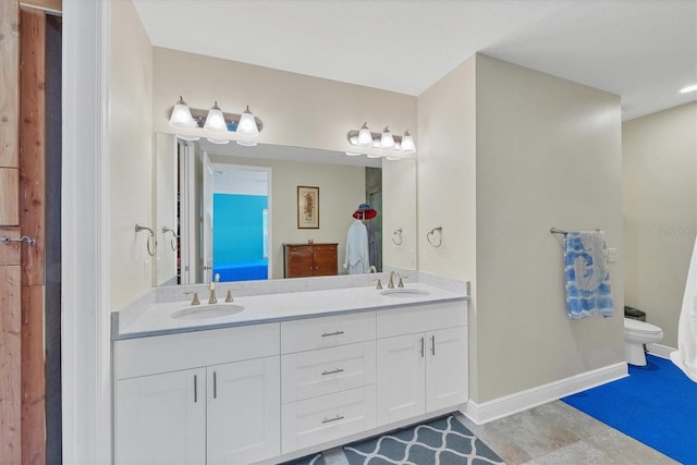 bathroom featuring tile patterned floors, vanity, and toilet