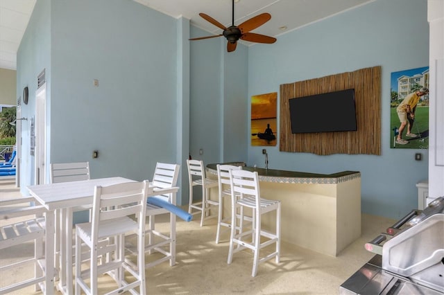 view of patio with ceiling fan and exterior bar