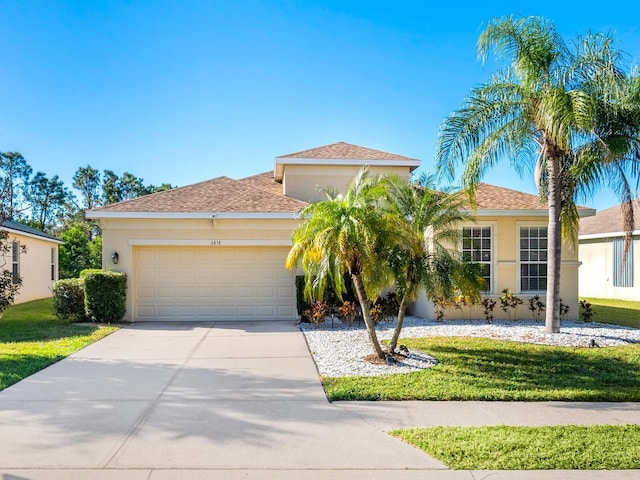 mediterranean / spanish-style house with a front yard and a garage