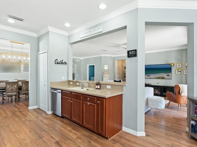 kitchen featuring crown molding, sink, dishwasher, light hardwood / wood-style floors, and hanging light fixtures