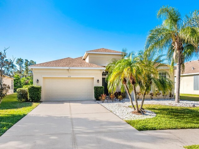 view of front facade with a front yard and a garage