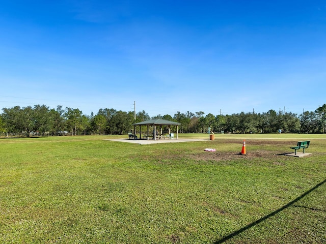 surrounding community with a gazebo and a yard