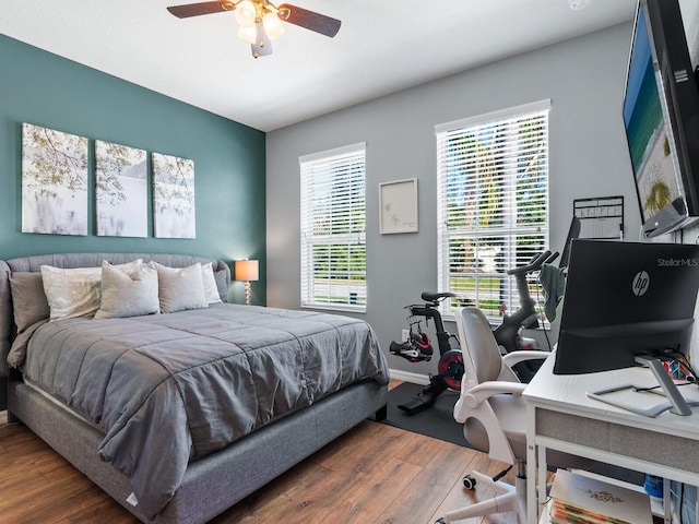 bedroom with ceiling fan and dark wood-type flooring