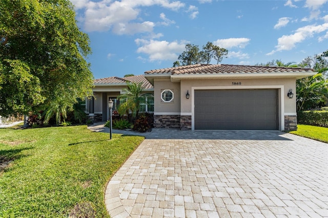 mediterranean / spanish-style house with a garage and a front yard