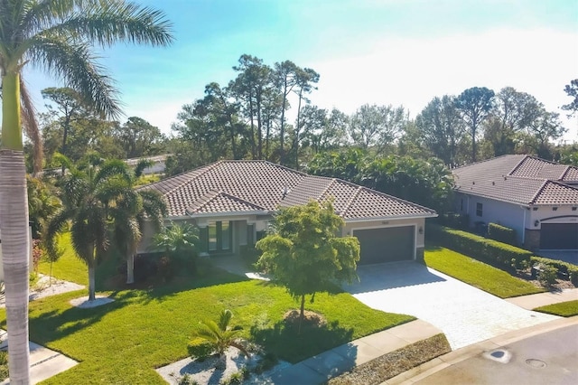 mediterranean / spanish-style house with a garage and a front lawn