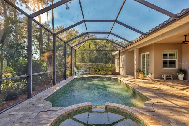 view of pool with an in ground hot tub, a patio, ceiling fan, and a lanai