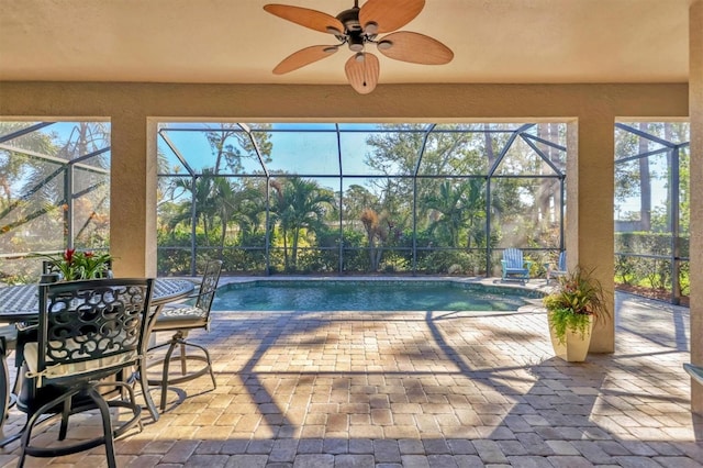 view of pool featuring a patio, ceiling fan, and a lanai