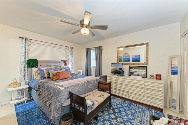 tiled bedroom with ceiling fan