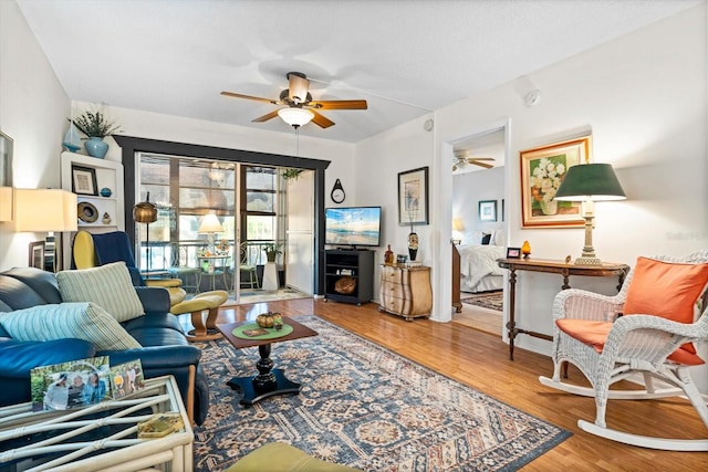 living room featuring hardwood / wood-style floors and ceiling fan