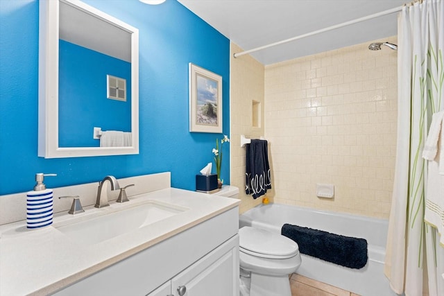 full bathroom with tile patterned floors, vanity, shower / tub combo, and toilet