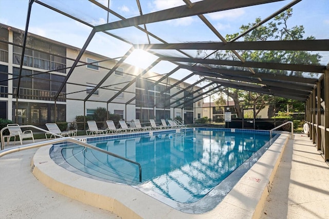 view of pool featuring a patio and glass enclosure