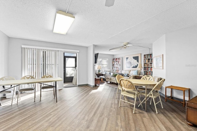 dining room featuring ceiling fan, a textured ceiling, and light wood-type flooring