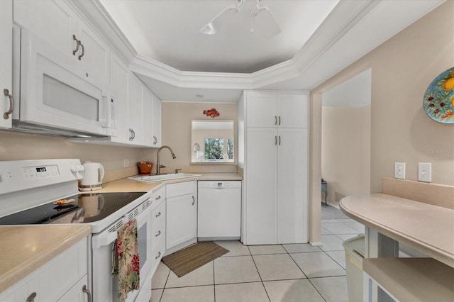 kitchen with white appliances, a raised ceiling, sink, light tile patterned flooring, and white cabinetry