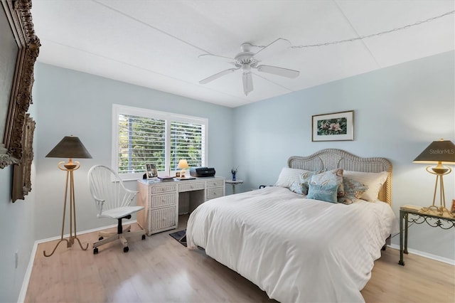 bedroom with ceiling fan and light hardwood / wood-style floors