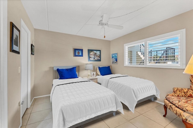 bedroom with ceiling fan and light tile patterned flooring